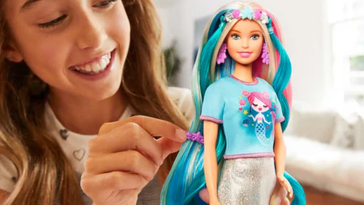 Close up on a plate of mashed potatoes, topped with baked pork chops with cream of mushroom soup, and a side of green beans.